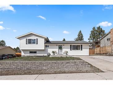Charming, updated home with a well-manicured lawn and lovely curb appeal on a sunny day at 217 Douglas Fir Ave, Castle Rock, CO 80104