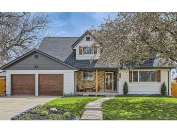 Charming two-story home with a well-manicured lawn, stone accents, and a two-car garage, inviting curb appeal at 5886 Urban St, Arvada, CO 80004