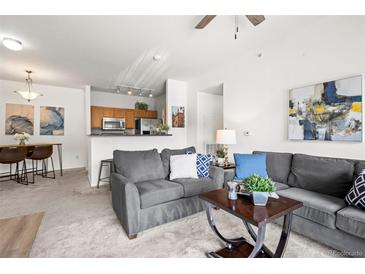 Inviting living room featuring comfortable seating and an open layout to the kitchen at 4451 S Ammons St # 4-203, Littleton, CO 80123