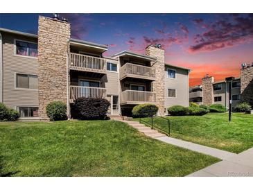 Well-maintained condo complex featuring stone accents, private balconies and landscaped grounds at 381 S Ames St # G101, Lakewood, CO 80226