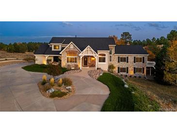 Stunning two-story home with stone accents and a well-manicured front yard at 5790 Fox Run Ct, Parker, CO 80134