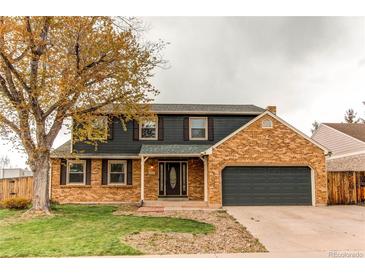 Charming two-story home featuring a brick facade, attached garage, and a well-maintained front yard at 10109 W Fremont Ave, Littleton, CO 80127