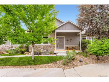 Charming single-Gathering home with stone accents, a well-manicured lawn, and a cozy front porch at 2716 Dundee Pl, Erie, CO 80516