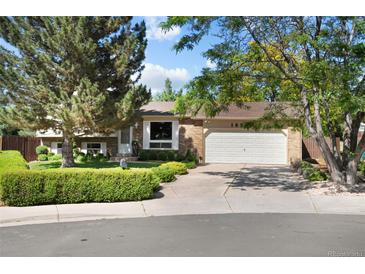 Charming brick home featuring a well-manicured lawn and a two-car garage at 16563 E Kansas Pl, Aurora, CO 80017