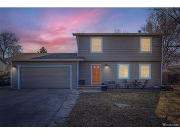 Charming two-story home featuring a well-maintained lawn, attached garage, and a cozy seating area, perfect for outdoor relaxation at 114 Walnut Dr, Frederick, CO 80530