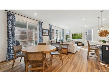 Bright living room with hardwood floors and abundant natural light at 17214 W 94Th Ave, Arvada, CO 80007
