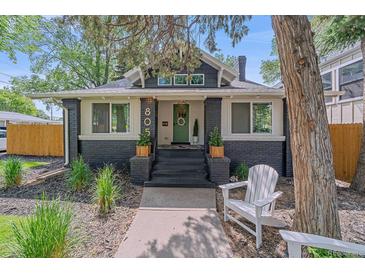 Charming renovated bungalow with a welcoming front porch and dark brick accents, ready for relaxing in this vibrant neighborhood at 805 Elm St, Denver, CO 80220