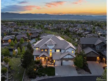 Expansive home featuring mountain views, neutral colors, and professional landscaping at 10525 Sunshower Pl, Highlands Ranch, CO 80126