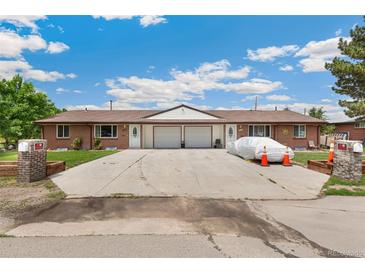 Charming duplex with brick exterior, driveway, garage, and well-maintained lawns, perfect for comfortable living at 5645 W 5Th Ave # 5645 & 5655, Lakewood, CO 80226