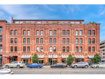 Classic brick building with awnings and street parking, offering a vibrant urban living experience at 1745 Wazee St # 2B, Denver, CO 80202