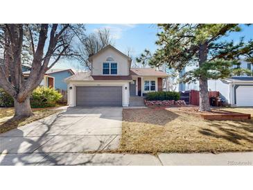 Charming home with a two-car garage and manicured lawn, creating a welcoming curb appeal at 3206 Columbine Ct, Broomfield, CO 80020