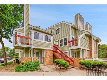 Multi-level townhouse featuring brick accents, red staircases and private balconies at 922 S Dearborn Way # 8, Aurora, CO 80012