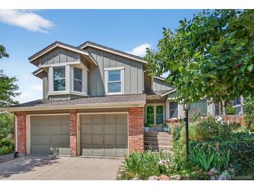 Charming two-story home featuring a well-manicured front yard, two car garage and brick accents at 11245 San Joaquin Rdg, Littleton, CO 80127