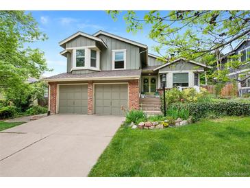 Charming two-story home featuring a well-manicured lawn and a two-car garage at 11245 San Joaquin Rdg, Littleton, CO 80127