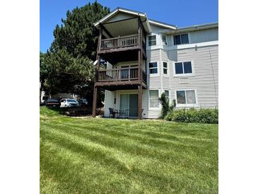 Exterior of a multi-level home with balconies overlooking a well-maintained lawn at 17361 E Mansfield Ave # 521R, Aurora, CO 80013