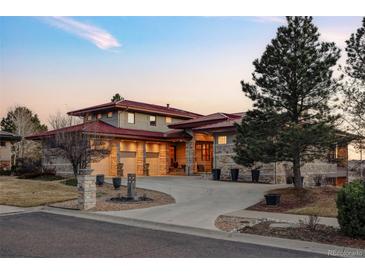 Stunning home with a well manicured front lawn, and a multi-car garage at 24360 E Glasgow Dr, Aurora, CO 80016