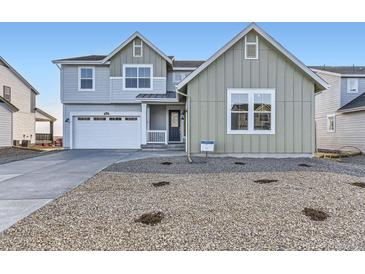 Inviting two-story home with a two-car garage, neat landscaping and charming architectural details at 39886 Floyd St, Elizabeth, CO 80107