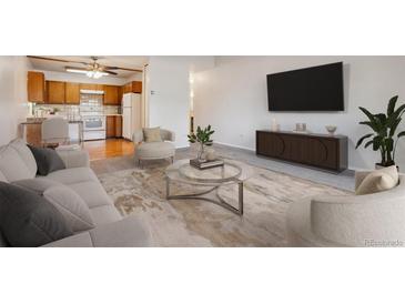 Comfortable living room featuring stylish furnishings and an open layout flowing into the kitchen at 755 S Alton Way # 8D, Denver, CO 80247