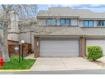 Charming townhome featuring a two-car garage and neutral color scheme on a sunny day at 155 Xenon St # 33, Denver, CO 80228