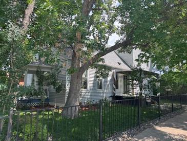 Charming home with a well-maintained yard and mature trees, offering shade and curb appeal at 3098 W 39Th Ave, Denver, CO 80211
