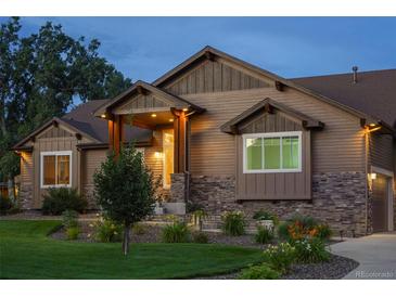 Beautiful single-Gathering home featuring manicured landscaping and a welcoming, covered front porch at 7130 Independence St, Arvada, CO 80004