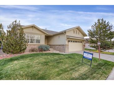 Charming single-Gathering home featuring a well-maintained lawn and inviting two-car garage at 23730 E Otero Dr, Aurora, CO 80016
