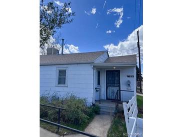 Exterior shot of single story home with white siding and small front yard at 3816 W Dakota Ave, Denver, CO 80219