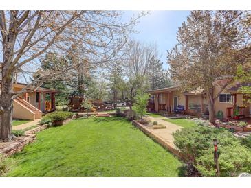 Exterior of building with trees and green lawn at 1460 Quince Ave # 102, Boulder, CO 80304