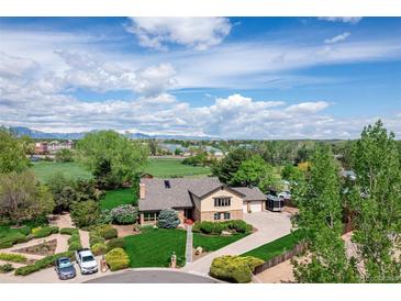A beautiful home with large yard, lush greenery, and long driveway, aerial view at 10037 Allison Ct, Broomfield, CO 80021