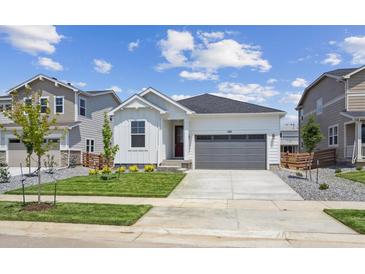 Charming single-story home featuring a well-maintained lawn, gray garage, and inviting curb appeal at 1321 Rock Cliff Ave, Erie, CO 80516