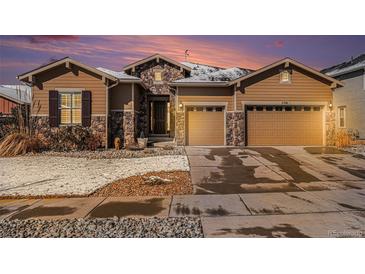 Charming home featuring stone accents, a two-car garage, and well-maintained landscaping at 11541 Quartzite Way, Parker, CO 80138