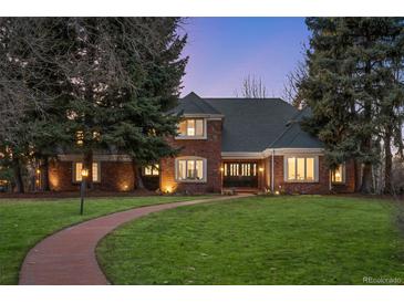 Charming brick home featuring a beautifully landscaped front yard and pathway leading to the entrance at 7 Cherry Hills Farm Dr, Cherry Hills Village, CO 80113