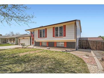 Charming two-story home with an attached garage, tidy lawn and brick accents at 1207 S Memphis St, Aurora, CO 80017