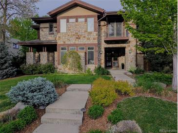 Stunning stone home with manicured lawn and landscaping offers timeless elegance and curb appeal at 230 Hudson St, Denver, CO 80220