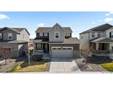 Charming two-story home with a well-manicured lawn, gray siding and a two-car garage at 432 N Patsburg St, Aurora, CO 80018