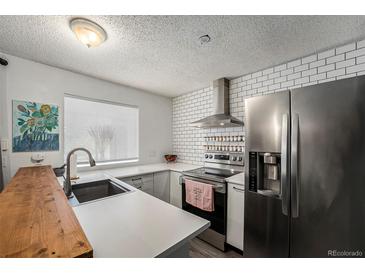 Modern kitchen featuring stainless steel appliances and white subway tile at 17111 E Stanford Ave # C, Aurora, CO 80015