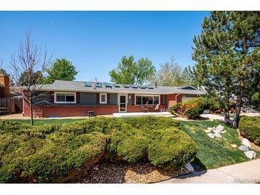 Charming single-story home with brick accents, skylights, and mature landscaping at 6995 S Kendall Blvd, Littleton, CO 80128