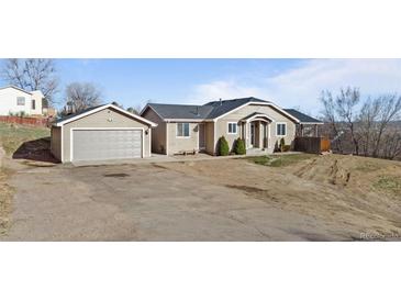 Charming single-Gathering home featuring a detached garage and a spacious front yard at 3230 S Decatur St, Denver, CO 80236