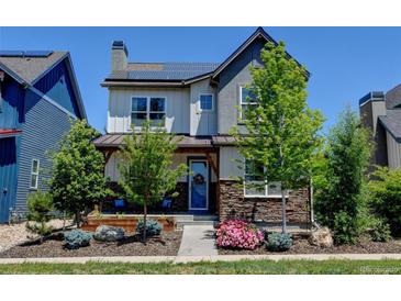 Charming two-story home featuring stone accents, covered porch, and solar panels at 1362 Golden Eagle Way, Louisville, CO 80027