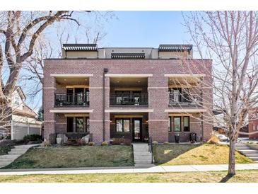 Beautiful three-story brick building with balconies and well-maintained landscaping at 1688 S Grant St, Denver, CO 80210