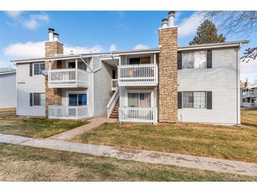 Inviting two-story condo with stone accents and a cozy, covered balcony for relaxing outdoors at 14454 E Colorado Dr # 103, Aurora, CO 80012