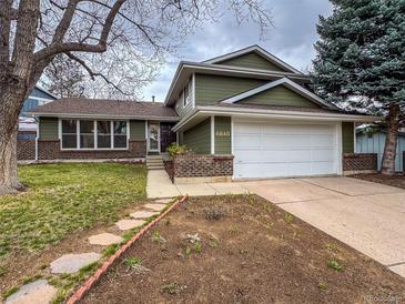 Charming two-story home featuring an attached two car garage and manicured lawn and garden at 6640 S Heritage W Pl, Centennial, CO 80111
