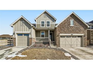 Charming home with two-car garage, stone accents, covered entry, and pleasant landscaping at 17632 Datura St, Broomfield, CO 80023