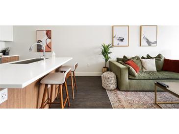 A stylish living room featuring a modern kitchen island, comfortable seating, and elegant decor at 2880 Zuni St # 309, Denver, CO 80211