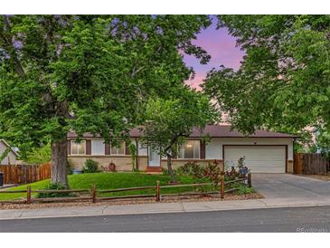 Charming one-story home featuring a well-maintained yard, mature trees, and an attached two-car garage at 16839 E Amherst E Ave, Aurora, CO 80013