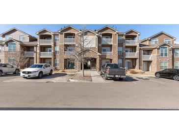 Attractive multi-story condo building featuring stone accents, balconies, and convenient parking at 7440 S Blackhawk St # 4-105, Englewood, CO 80112