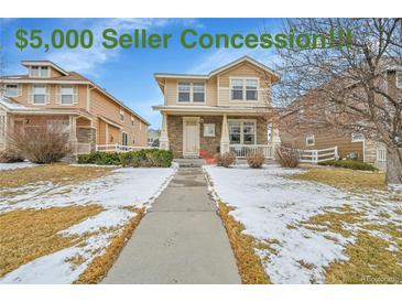 Charming two-story home featuring a welcoming front porch and manicured lawn, complemented by a $5,000 seller concession at 23601 E Mississippi Cir, Aurora, CO 80018