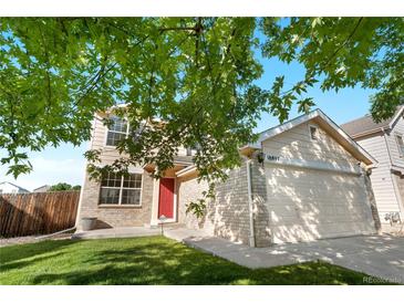 Inviting two-story home with a red door and a well-maintained lawn at 18897 E Linvale Pl, Aurora, CO 80013