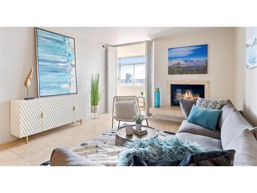 Bright living room featuring modern decor, fireplace, and balcony access with city views at 1313 N Williams St # 1103, Denver, CO 80218