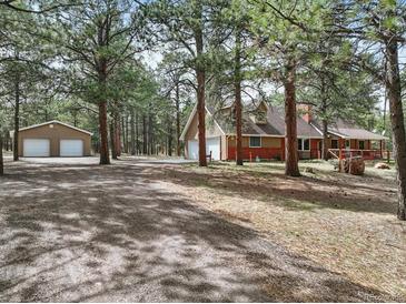 Charming home with a detached garage surrounded by beautiful mature trees at 17720 Canterbury Dr, Monument, CO 80132